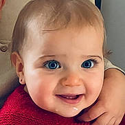 Leya participe au concours pour gagner de l'argent avec cette photo : baby, child, blue_eyes, smiling, red_sweater, knitted_clothing, close_up, indoor, hug, hand, face, cute, portrait, infant, young_child, warmth, happy, person, soft_light, cozy