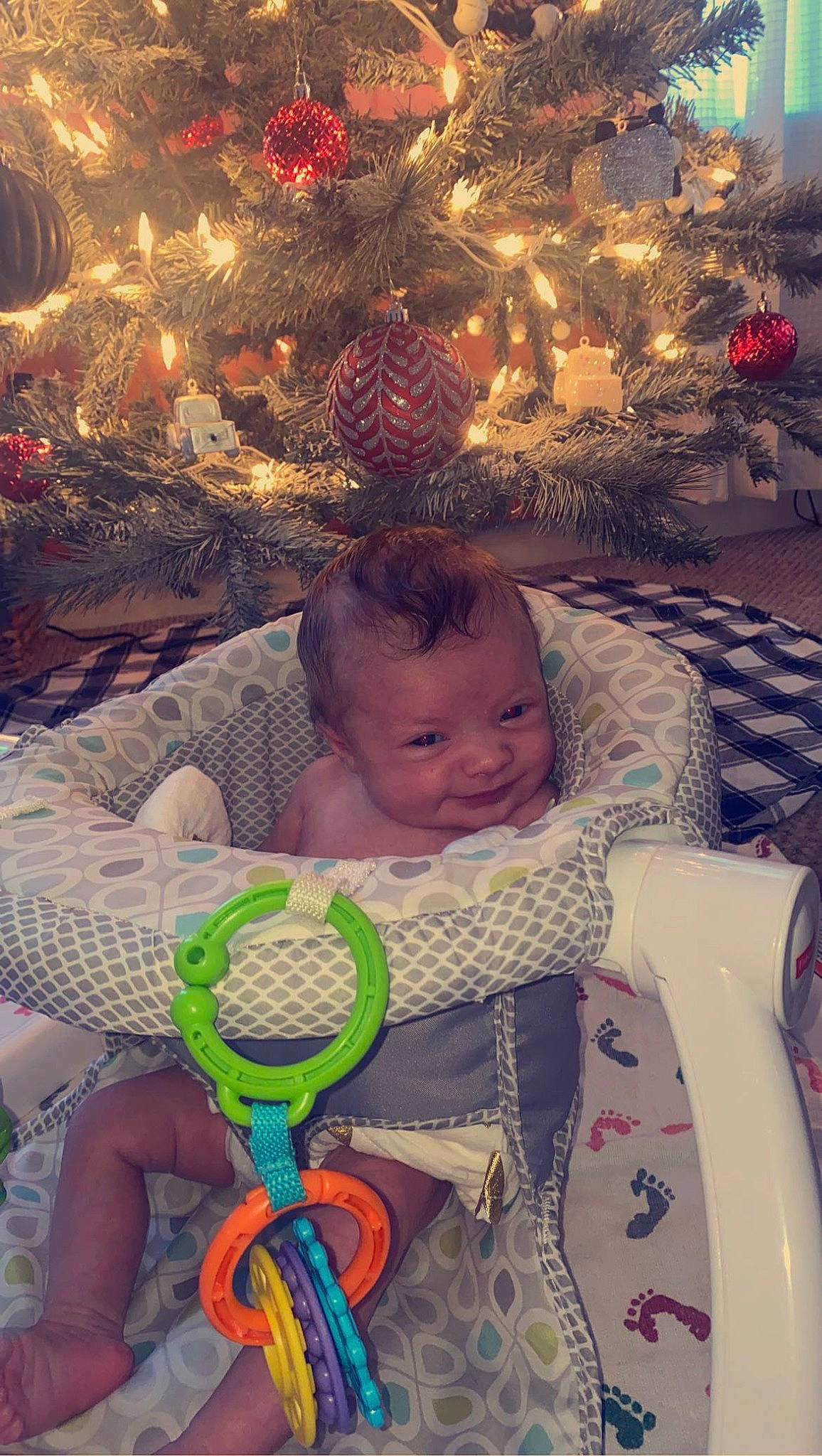 Ava Mae is registered to the contest to win money with this photo: baby, baby_products, baby_toddler_clothing, beauty, child, christmas_tree, comfort, event, fun, happy, lap, organ, ornament, people, person, photograph, product, sitting, snapshot, textile