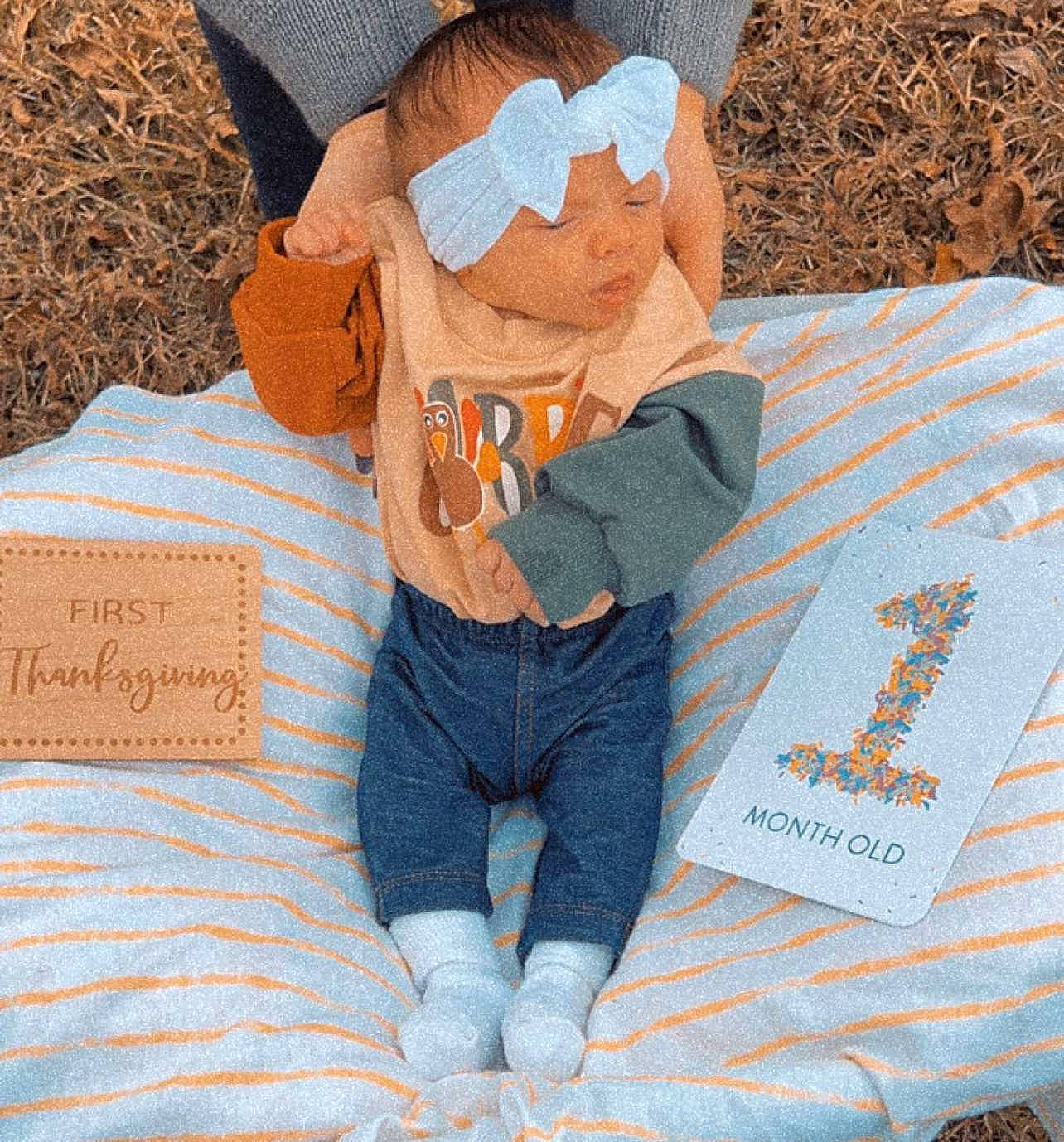 Ava Mae joined the competition — help win amazing prizes! azure, baby_products, baby_sleeping, baby_toddler_clothing, bag, bedding, child, comfort, electric_blue, grass, hat, linens, orange, pattern, person, product, sitting, stuffed_toy, textile, toy