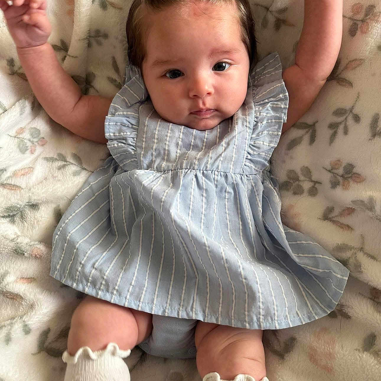 Ari Rose is registered to the contest to win money with this photo: baby, beachwear, blanket, blonde, bodypart, clothing, dress, face, finger, hair, hand, head, newborn, person, photography, portrait, quilt, sitting, sleeve, toy