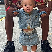 Nylah is registered to the contest to win money with this photo: toddler, child, denim_jacket, denim_skirt, sneakers, adult_hands, sidewalk, street, gold_necklace, shorts, floral_pattern, curly_hair, blue_eyes, casual_clothing, urban, holding_hands, outdoor, fashion, expression, person