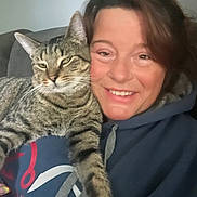 Snoop joined the competition — help win amazing prizes! woman, cat, tabby_cat, smiling, indoor, couch, hoodie, face, pet, feline, comfort, snuggling, relaxed, casual, portrait, happy, home, animal, friendship, closeup