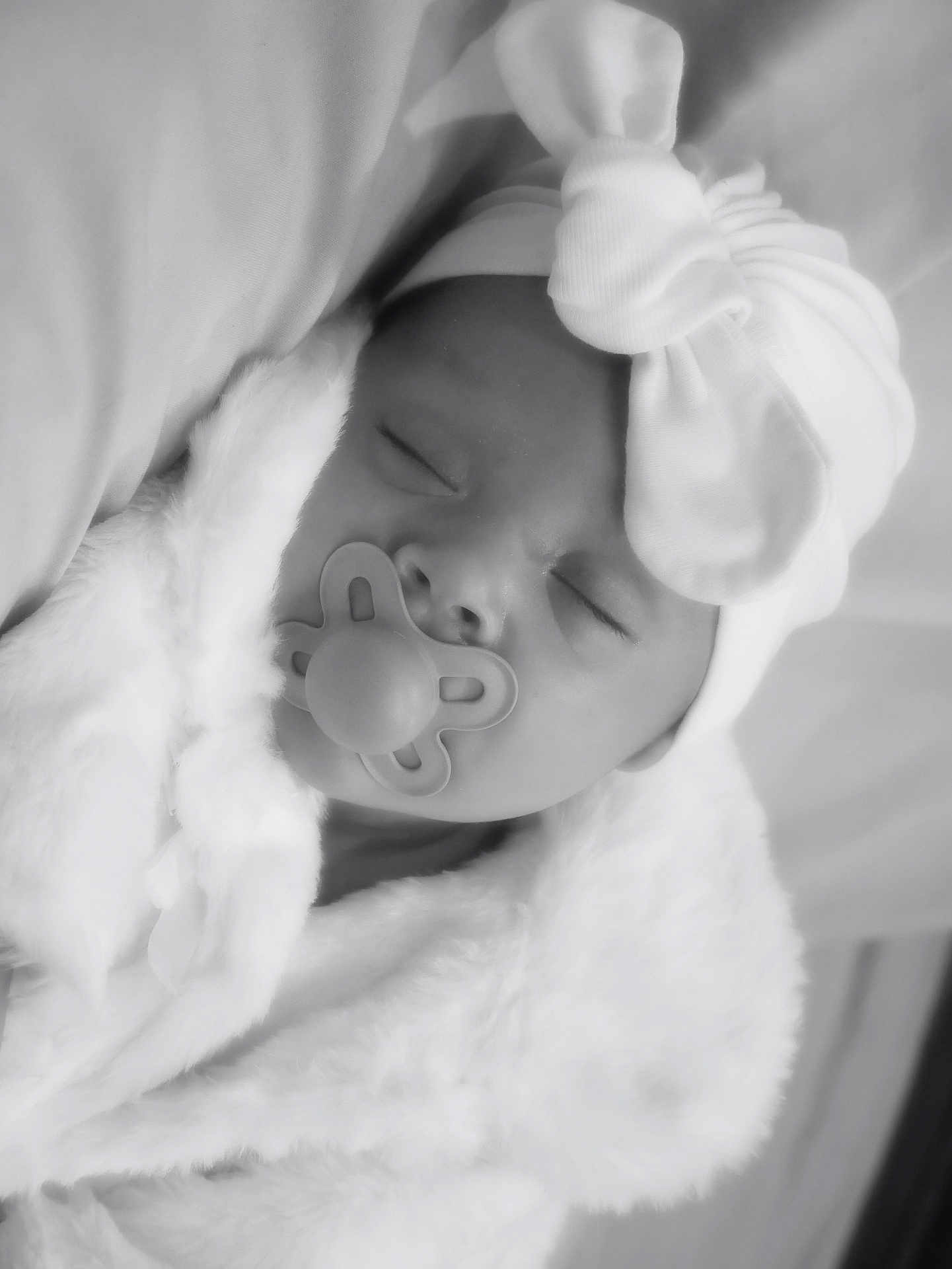 Reyli joined the competition — help win amazing prizes! baby, pacifier, blanket, bow, hat, sleeping, face, infant, soft, monochrome, portrait, cute, newborn, cozy, wrapped, peaceful, headwear, child, resting, closeup
