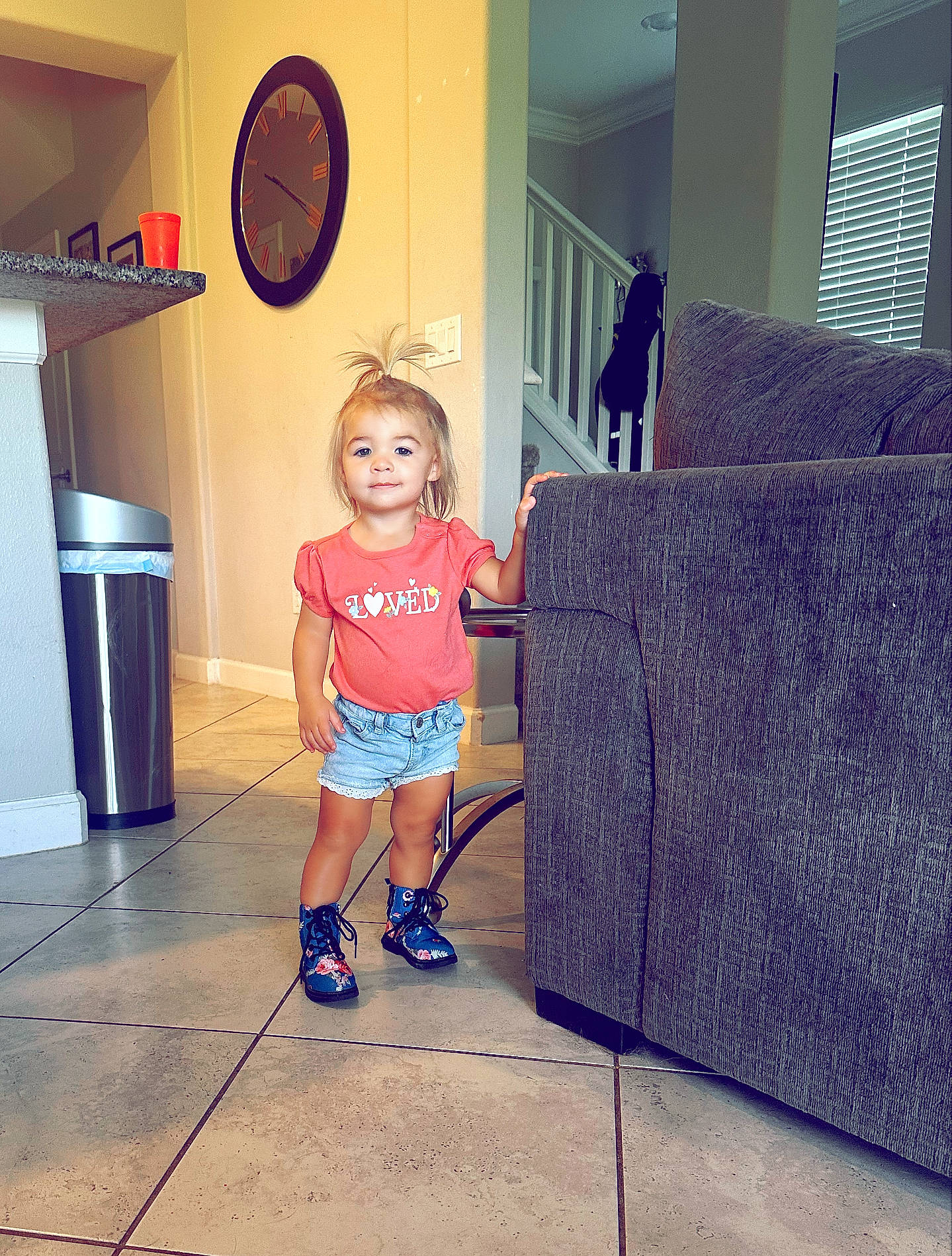 Aria Lynn is registered to the contest to win money with this photo: cool, couch, electric_blue, floor, flooring, fun, hardwood, human_leg, interior_design, magenta, person, purple, shoe, shorts, shoulder, t_shirt, thigh, toddler, waste_container, waste_containment