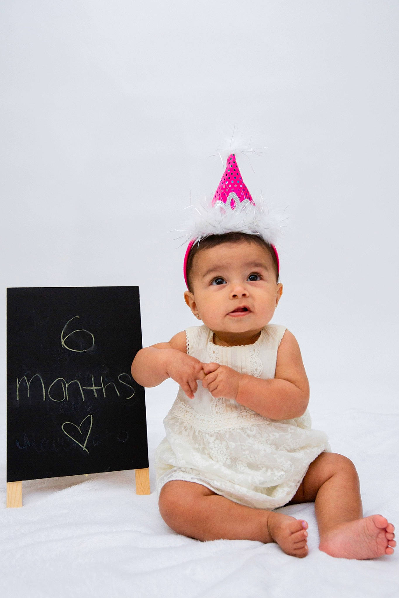 Akira joined the competition — help win amazing prizes! baby, baby_toddler_clothing, child, child_model, costume_accessory, costume_hat, crown, fashion_accessory, hair_accessory, head, headgear, headpiece, party_hat, pattern, person, photography, pink, product, sitting, skin