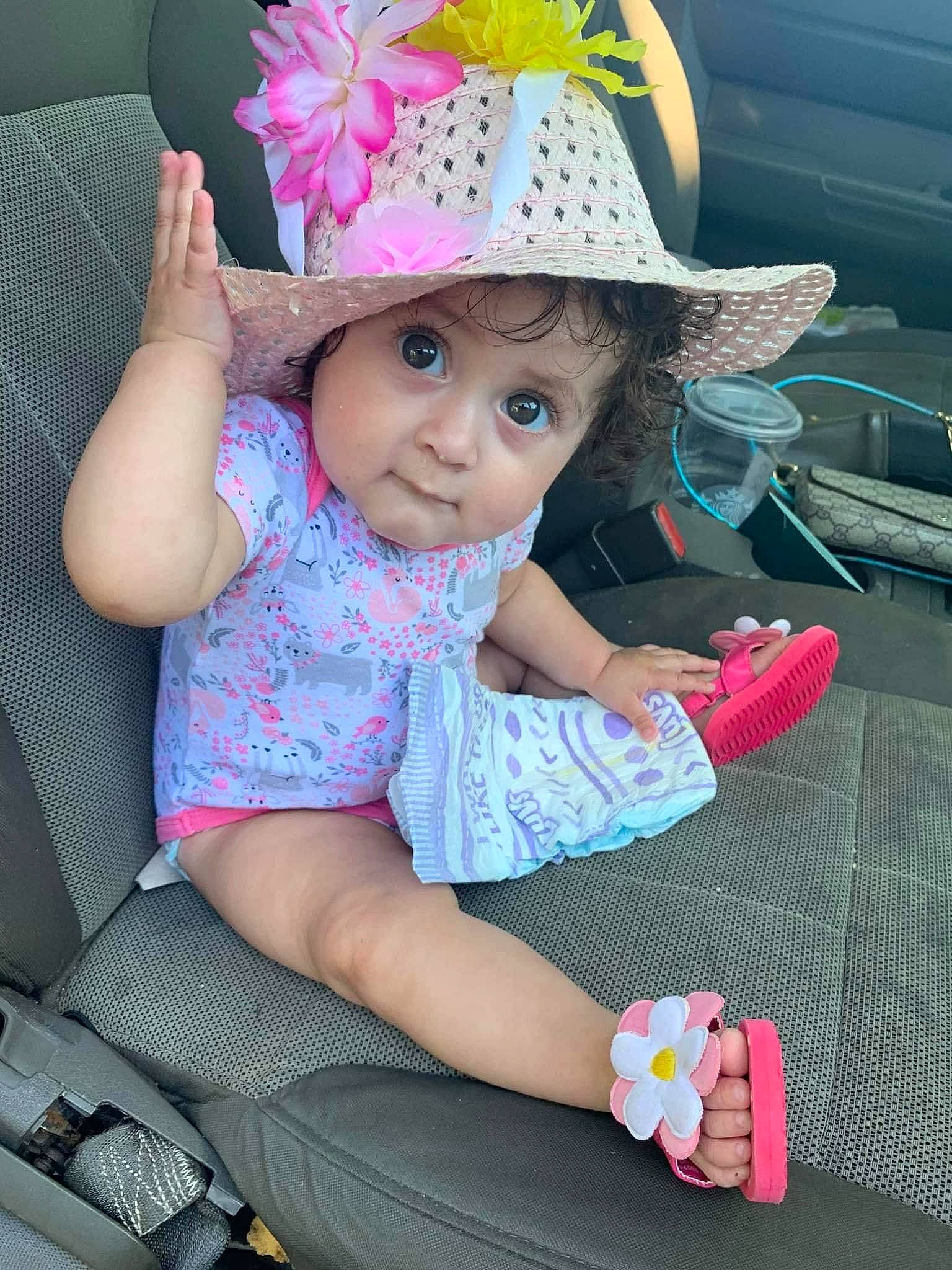 Leilani is registered to the contest to win money with this photo: baby_toddler_clothing, beauty, cap, child, costume_hat, finger, flower, fun, happy, hat, headwear, magenta, person, pink, product, purple, skin, sun_hat, textile, thigh