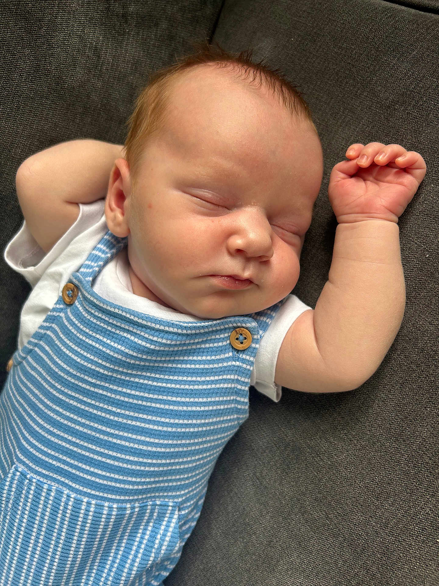 Theo joined the competition — help win amazing prizes! baby, sleeping, infant, blue_striped_outfit, white_shirt, arm, hand, face, closed_eyes, peaceful, resting, skin, couch, fabric, portrait, cute, child, newborn, relaxed, indoor