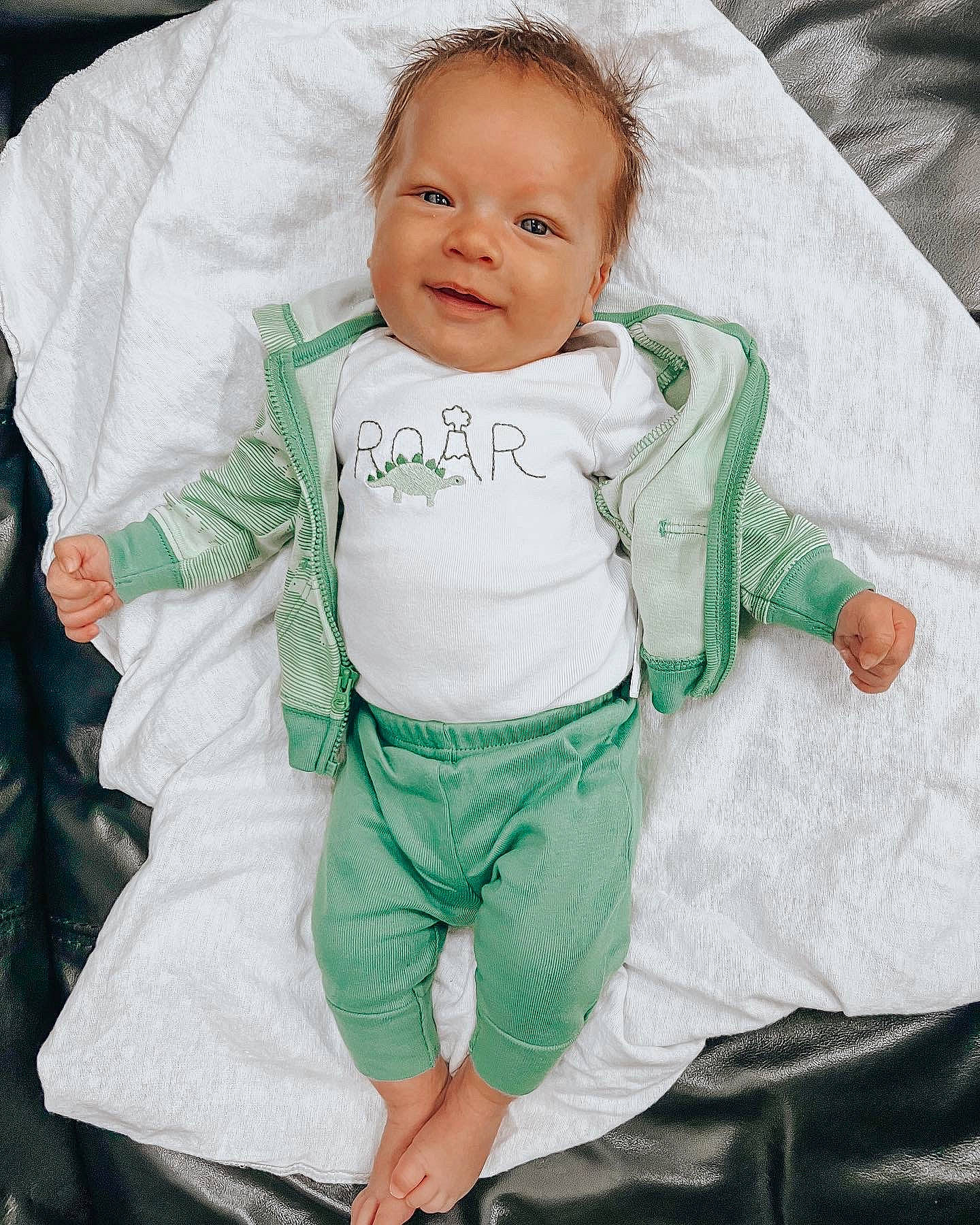 Kingston is registered to the contest to win money with this photo: baby, baby_products, baby_toddler_clothing, child, comfort, cool, eye, face, fun, gesture, happy, linens, pattern, person, photograph, sitting, sleeve, smile, t_shirt, toddler