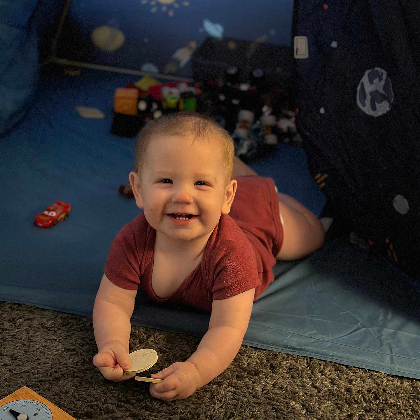 Jack is registered to the contest to win money with this photo: baby, car, clothing, coat, crawling, face, furniture, happy, head, indoors, laughing, person, photography, portrait, quilt, sitting, smile, t_shirt, transportation, vehicle