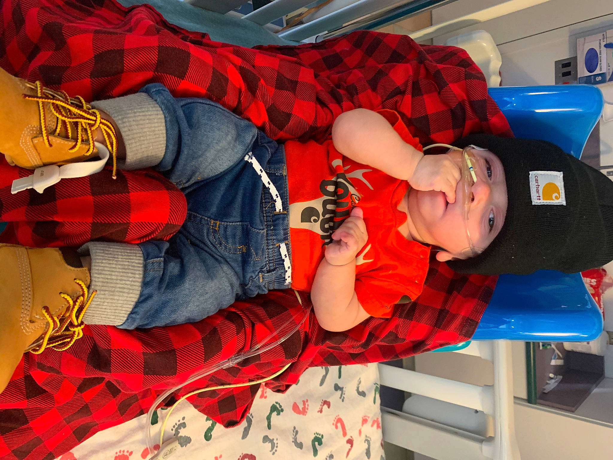 Leo is registered to the contest to win money with this photo: carmine, costume, elbow, electric_blue, fictional_character, fun, hat, headwear, human_leg, orange, pattern, person, personal_protective_equipment, plaid, red, sleeve, tartan, textile, thigh, toddler
