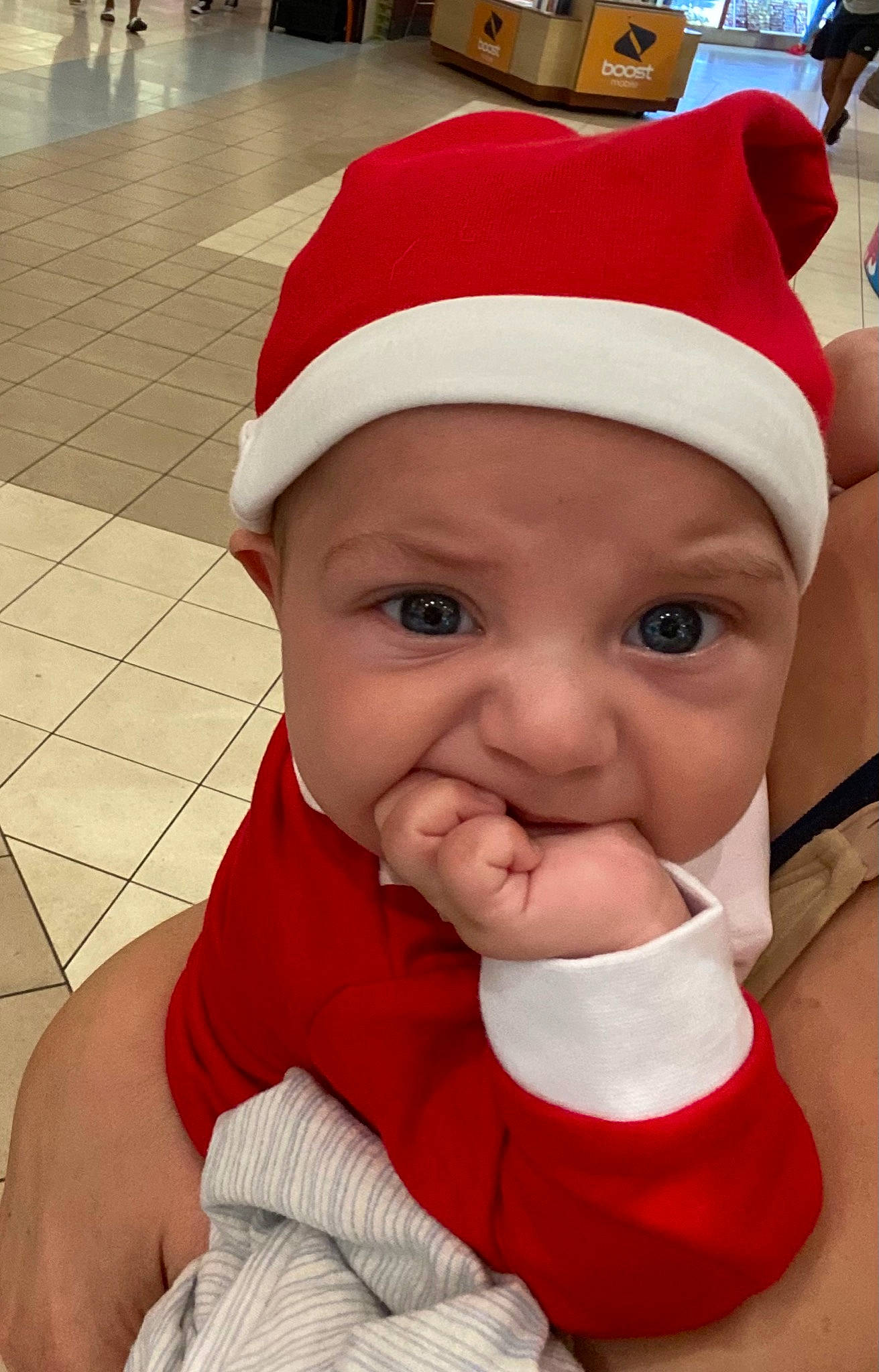 Joaquin is registered to the contest to win money with this photo: baby, baby_products, baby_toddler_clothing, carmine, christmas, christmas_eve, costume, costume_accessory, costume_hat, fictional_character, floor, headwear, holiday, person, tile, tile_flooring, toddler