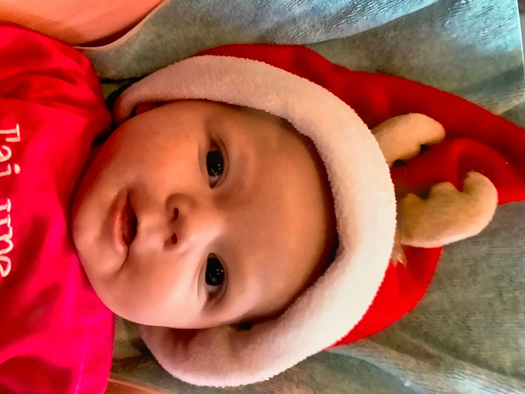 Ilyanna participe au concours pour gagner de l'argent avec cette photo : baby, baby_toddler_clothing, carmine, cheek, child, christmas, costume_accessory, eyebrow, fictional_character, fur, fur_clothing, headwear, linens, lip, person, photography, pleased, red, skin, textile