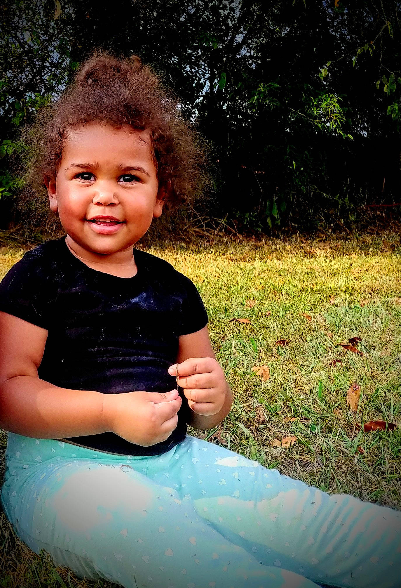 Neveah joined the competition — help win amazing prizes! child, fun, grass, happy, joy, person, photography, portrait, sitting, smile, toddler