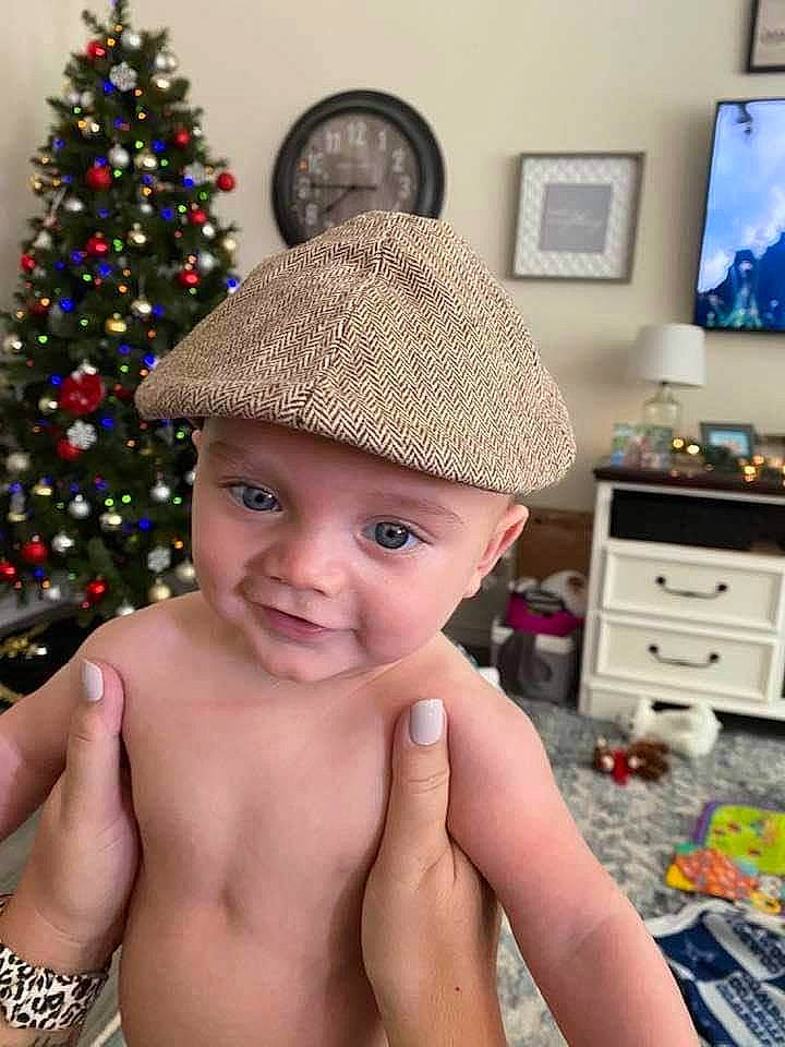 Cason joined the competition — help win amazing prizes! blue, cabinetry, cap, chest, chest_of_drawers, christmas_ornament, christmas_tree, drawer, finger, hand, happy, hat, headgear, headwear, holiday_ornament, ornament, person, photograph, snapshot, television