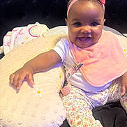 Walonii joined the competition — help win amazing prizes! baby, child, smiling, headband, pink_bib, cushion, floral_pants, sitting, indoors, happy, cute, infant, clothing, person, face, foot, hand, blanket, bed, comfort