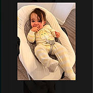 Leo joined the competition — help win amazing prizes! toddler, baby, pajamas, yellow, white, striped, baby_seat, cushion, floor, indoor, child, person, face, hand, footwear, expression, cute, comfort, relaxed, home