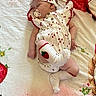 Tinley is registered to the contest to win money with this photo: baby, sleeping, blanket, strawberry, headband, pacifier, socks, infant, cute, pattern, clothing, lying_down, soft, child, rest, peaceful, skin, hand, foot, fabric