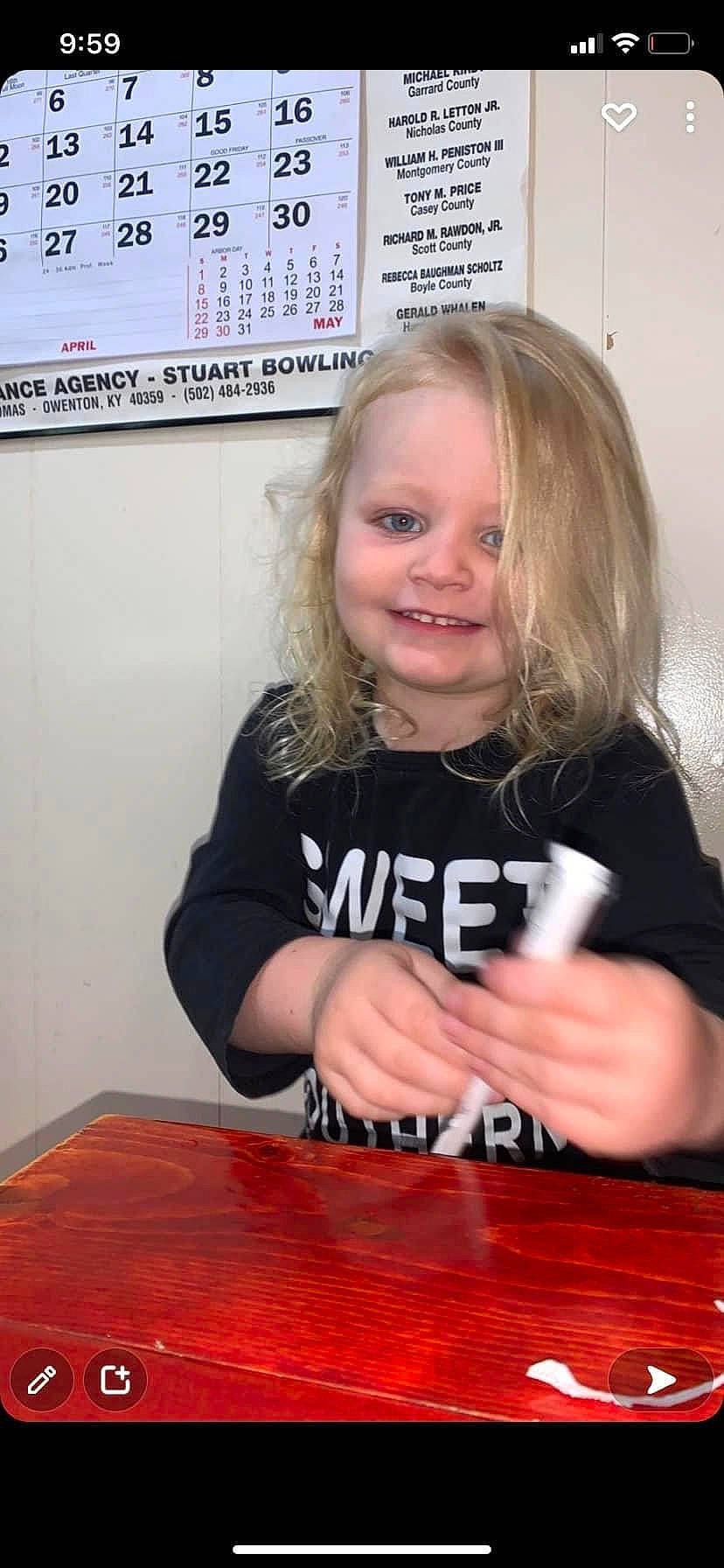 Adalee joined the competition — help win amazing prizes! arm, blond, eye, facial_expression, finger, flooring, fun, hair, hand, happy, hardwood, head, joy, person, sleeve, smile, t_shirt, table, toddler, varnish