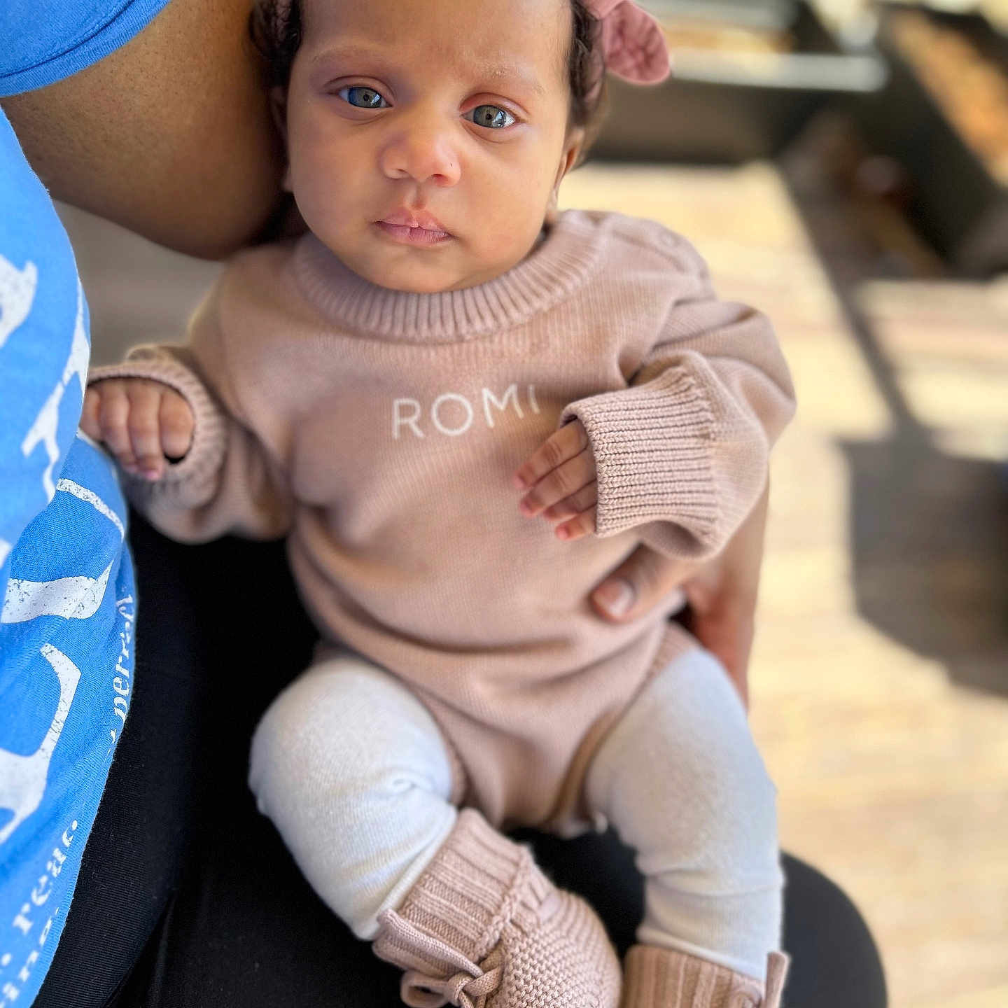 Romi is registered to the contest to win money with this photo: baby, bodypart, clothing, face, finger, footwear, frown, hand, happy, head, jeans, knitwear, pants, person, photography, portrait, shoe, sitting, smile, sweater