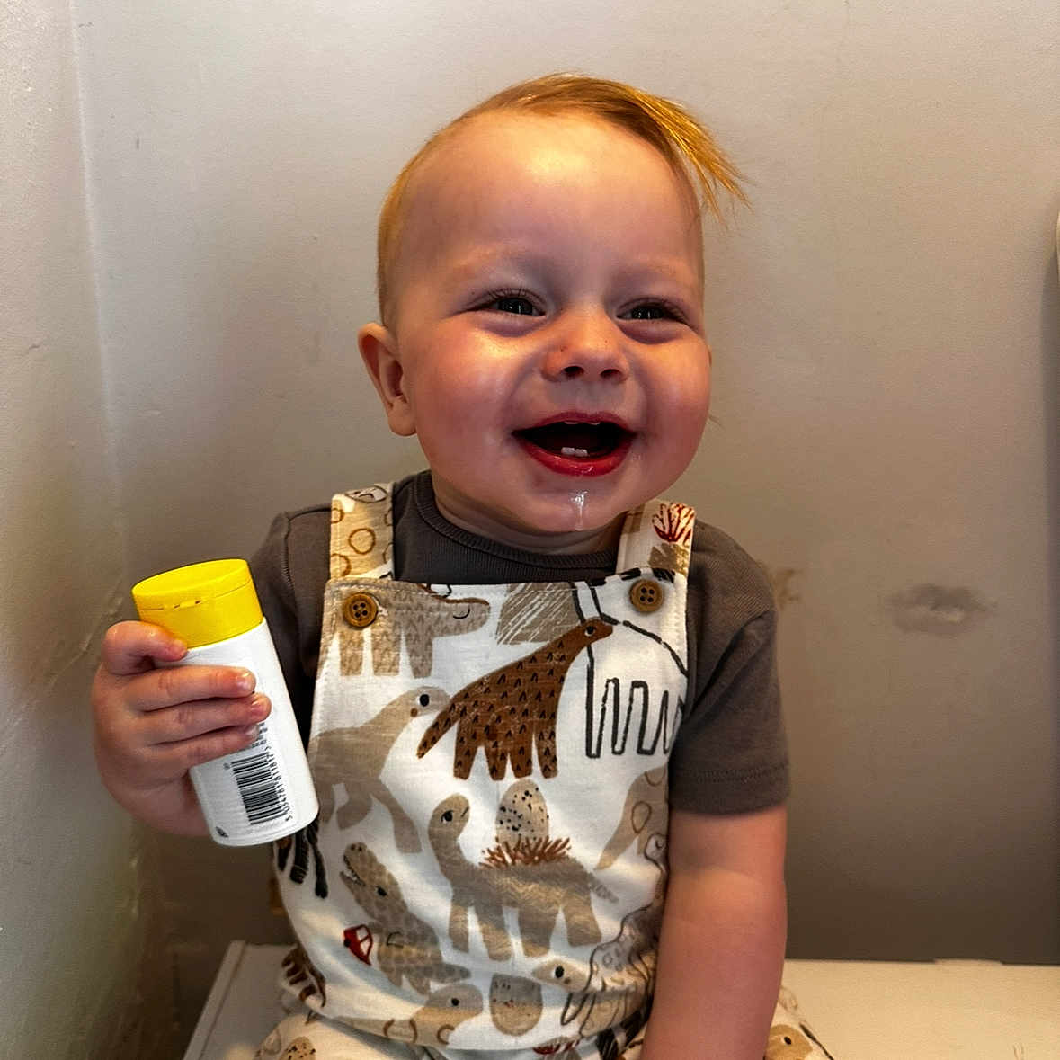 Noah is registered to the contest to win money with this photo: baby, babylaughing, bodypart, bottle, clothing, cream, dessert, face, finger, food, hand, happy, head, icecream, person, photography, portrait, sitting, smile, t_shirt