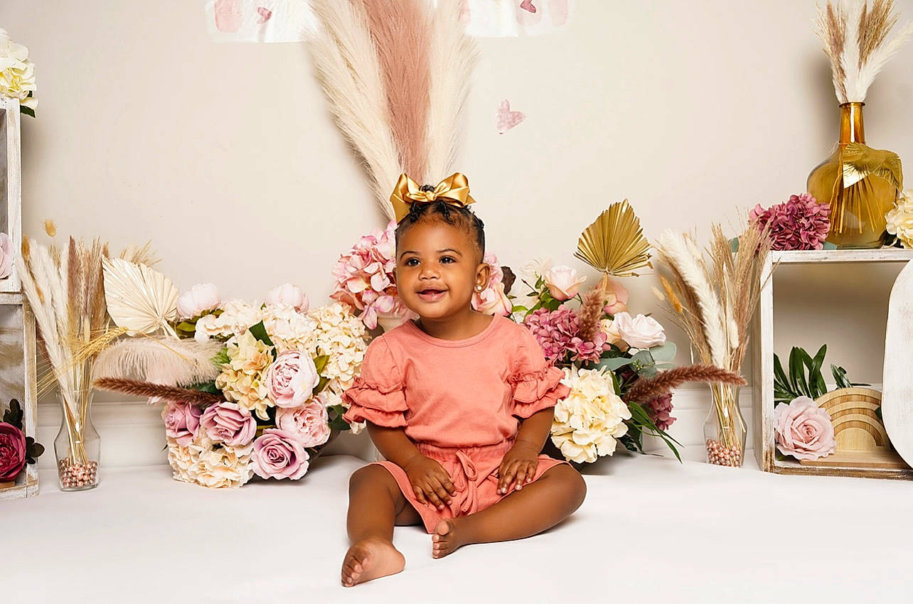 Reign is registered to the contest to win money with this photo: baby, baby_toddler_clothing, cut_flowers, event, fashion_accessory, floral_design, flower, flower_arranging, hair_accessory, happy, headpiece, joy, magenta, peach, person, petal, pink, plant, room, rose