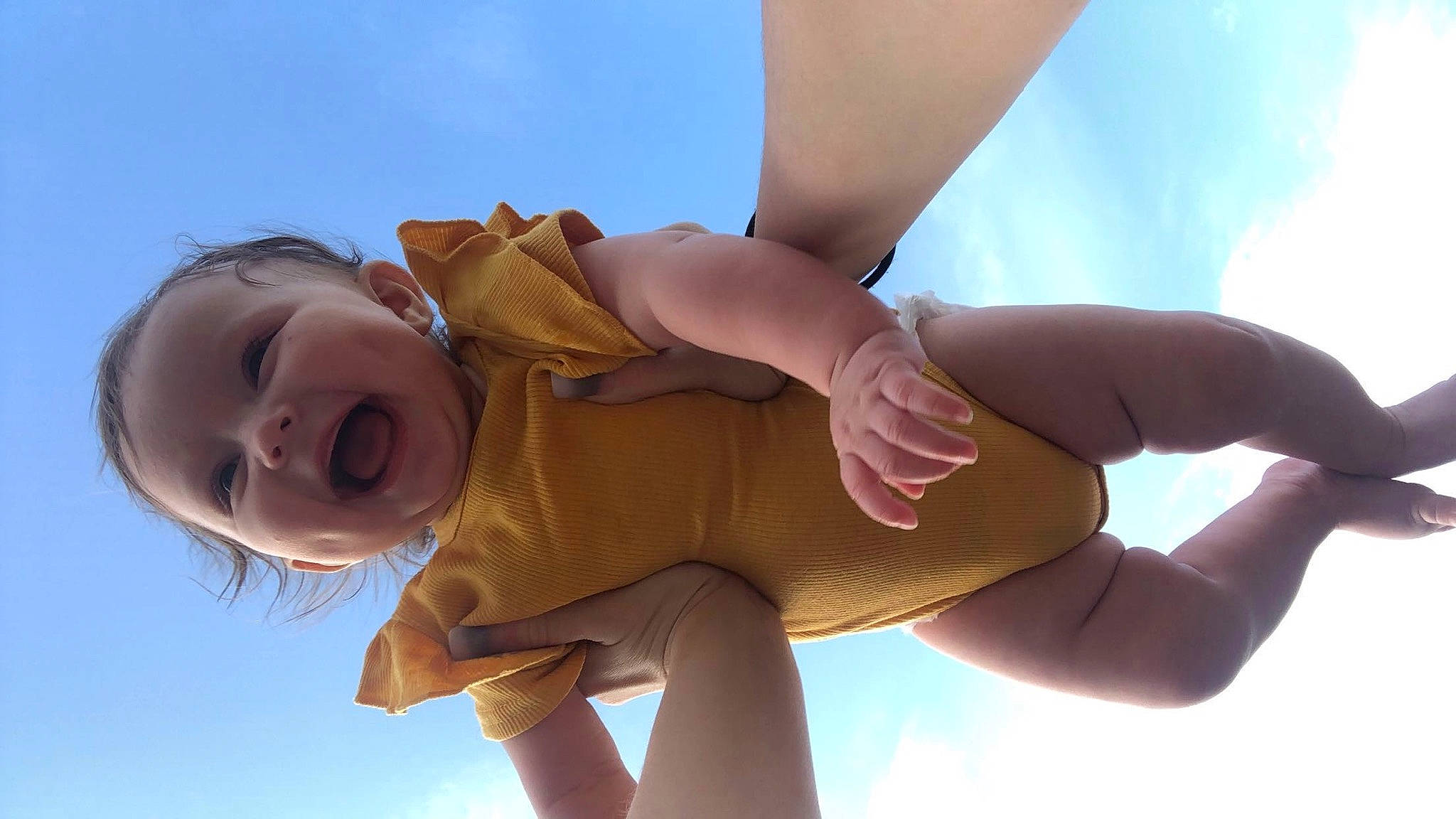 Nova is registered to the contest to win money with this photo: baby, baby_toddler_clothing, cloud, elbow, finger, flash_photography, fun, gesture, happy, human_body, human_leg, knee, leisure, people_in_nature, person, skin, sky, smile, thigh, thumb