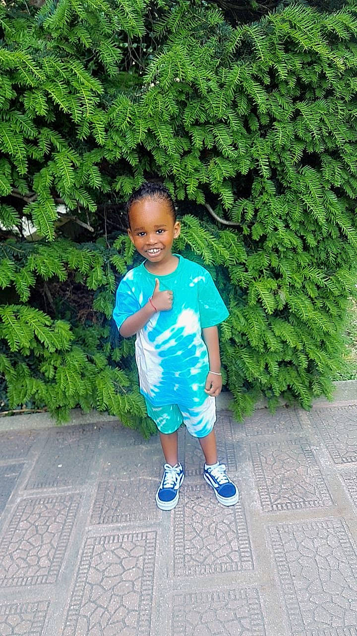 Cayden a rejoint le concours — aidez-le/la à gagner de superbes lots ! baby_toddler_clothing, child, electric_blue, fun, garden, grass, groundcover, happy, joy, leg, leisure, people_in_nature, person, plant, sandal, shorts, shrub, sidewalk, sleeve, t_shirt