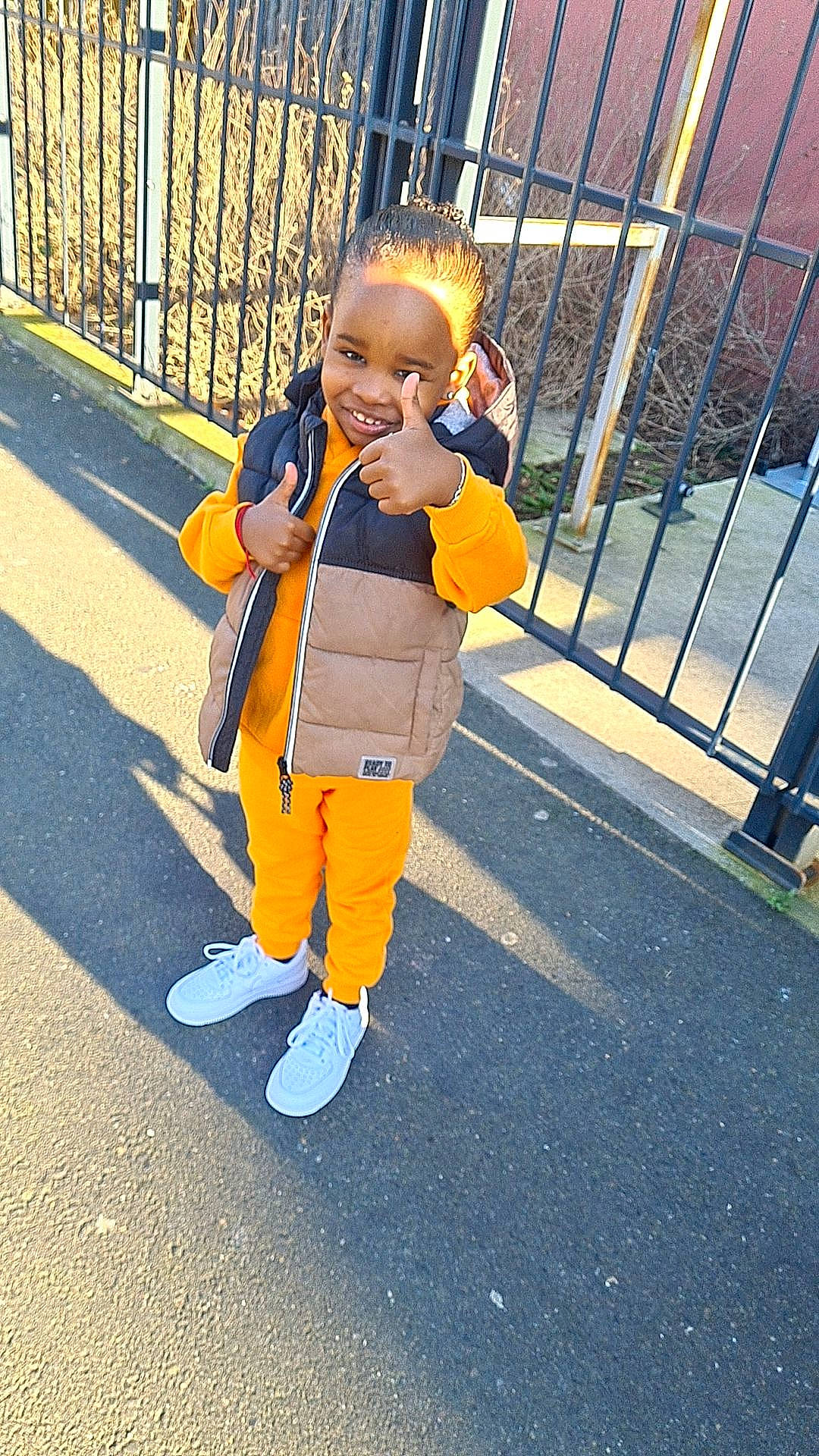 Cayden a rejoint le concours — aidez-le/la à gagner de superbes lots ! asphalt, baby, baby_toddler_clothing, child, city, electric_blue, fence, fun, gesture, happy, joy, leisure, pedestrian, person, recreation, road_surface, sidewalk, sleeve, smile, t_shirt