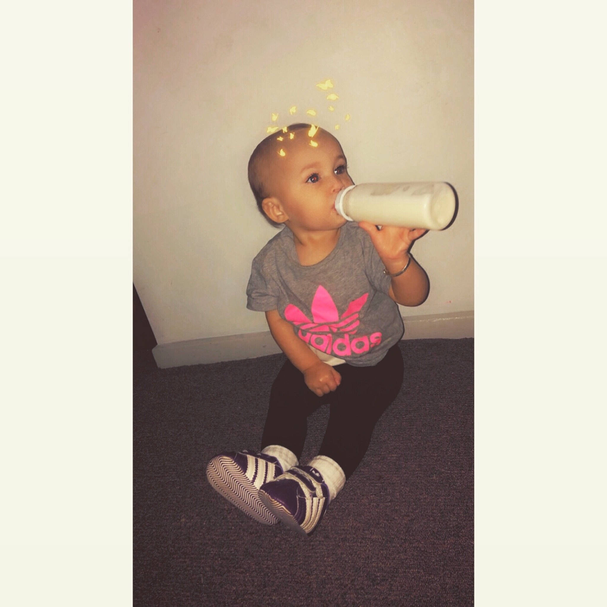 Khaila is registered to the contest to win money with this photo: arm, child, footwear, illustration, joint, leg, person, play, shoe, sitting, sleeve, smile, t_shirt, toddler