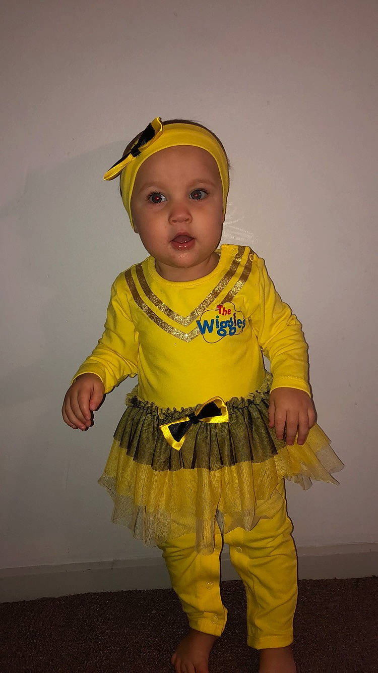 Khaila is registered to the contest to win money with this photo: child, clothing, costume, costume_accessory, outerwear, person, personal_protective_equipment, smile, toddler, yellow
