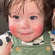 Gael joined the competition — help win amazing prizes! toddler, child, face, rosy_cheeks, brown_hair, green_overall, mickey_mouse, clothing, hand, portrait, cute, smile, indoor, baby, person, closeup, expression, young_child, apparel, holding