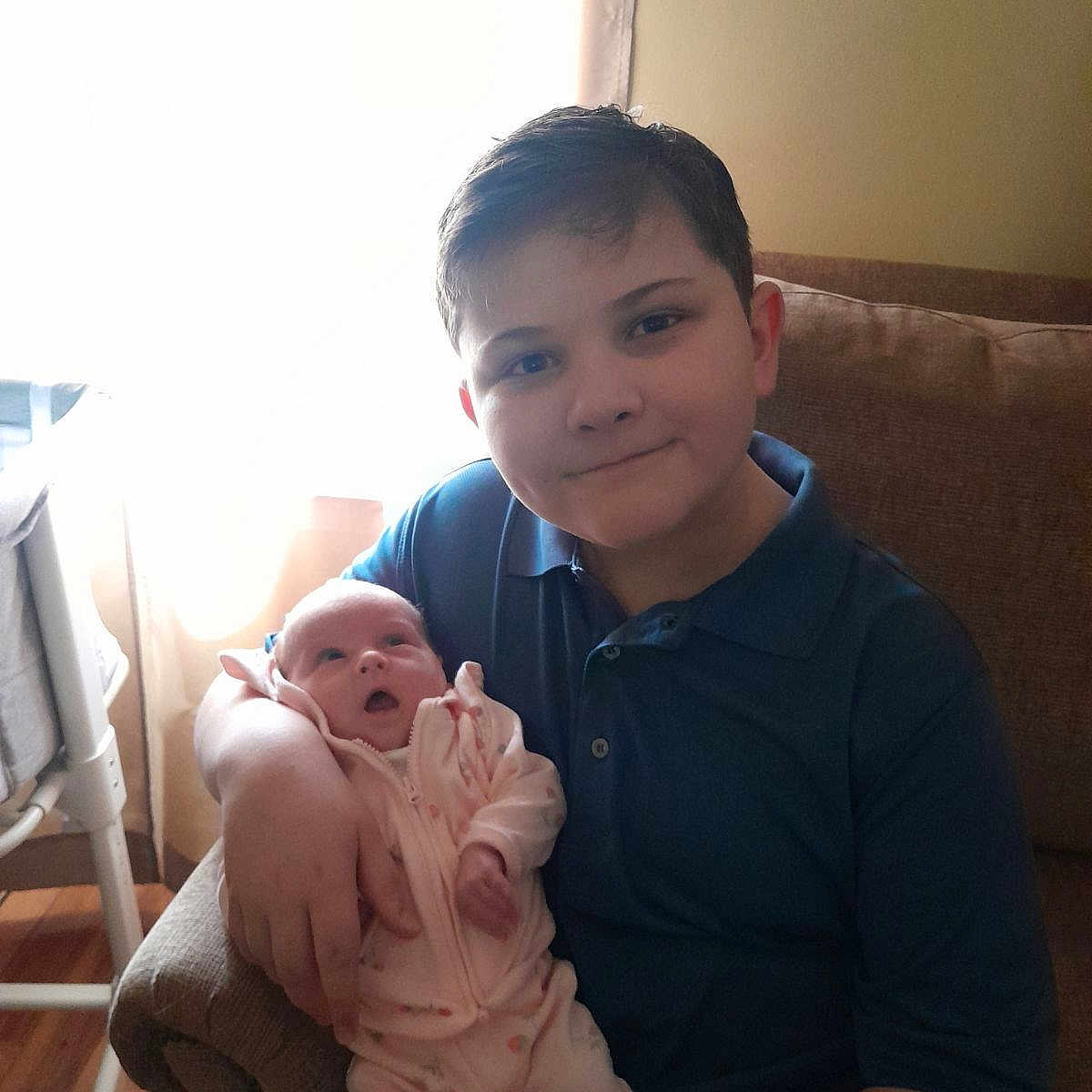 Johnny is registered to the contest to win money with this photo: architecture, baby, building, clothing, couch, cushion, face, furniture, head, homedecor, hospital, indoors, livingroom, newborn, people, person, photography, portrait, room, t_shirt