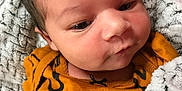 Nova joined the competition — help win amazing prizes! baby, infant, blanket, clothing, closeup, face, newborn, portrait, skin, soft, yellow, pattern, cute, child, cozy, warm, indoor, expression, person, newborn_baby