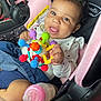 Nova joined the competition — help win amazing prizes! baby, black, bottle, car_seat, child, clothing, colorful_toy, comfort, cute, eyes, face, hand, happy, infant, pink, playful, seat, smiling, tongue, toy