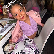 Cattleya is registered to the contest to win money with this photo: child, girl, smiling, sunglasses, pink_jacket, purple_top, patterned_pants, sitting, chair, restaurant, table, plate, fork, happy, indoor, fashion, casual, person, cute, playful