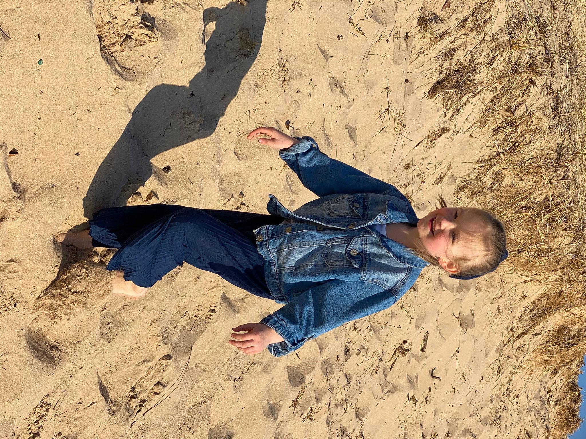 Arya joined the competition — help win amazing prizes! aeolian_landform, beach, comfort, denim, ecoregion, electric_blue, fun, happy, jeans, joy, landscape, leisure, people_in_nature, person, recreation, sand, shadow, singing_sand, sitting, soil