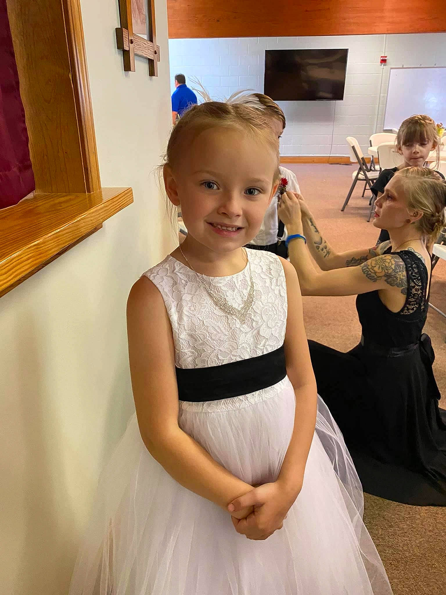 Arya joined the competition — help win amazing prizes! arm, bridal_clothing, bridal_party_dress, clothing, dress, face, gesture, gown, hair, hand, happy, joy, one_piece_garment, person, picture_frame, shoulder, skin, smile, standing, toddler