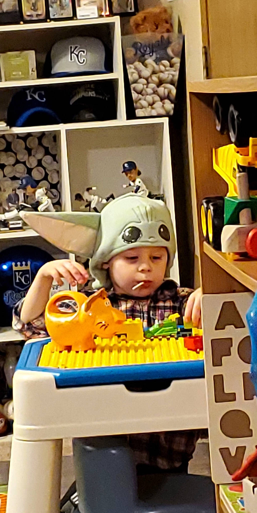 Oliver is registered to the contest to win money with this photo: animation, art, baby, child, collection, eyewear, fictional_character, fun, headwear, machine, person, personal_protective_equipment, play, recreation, room, toddler, toy, toy_block