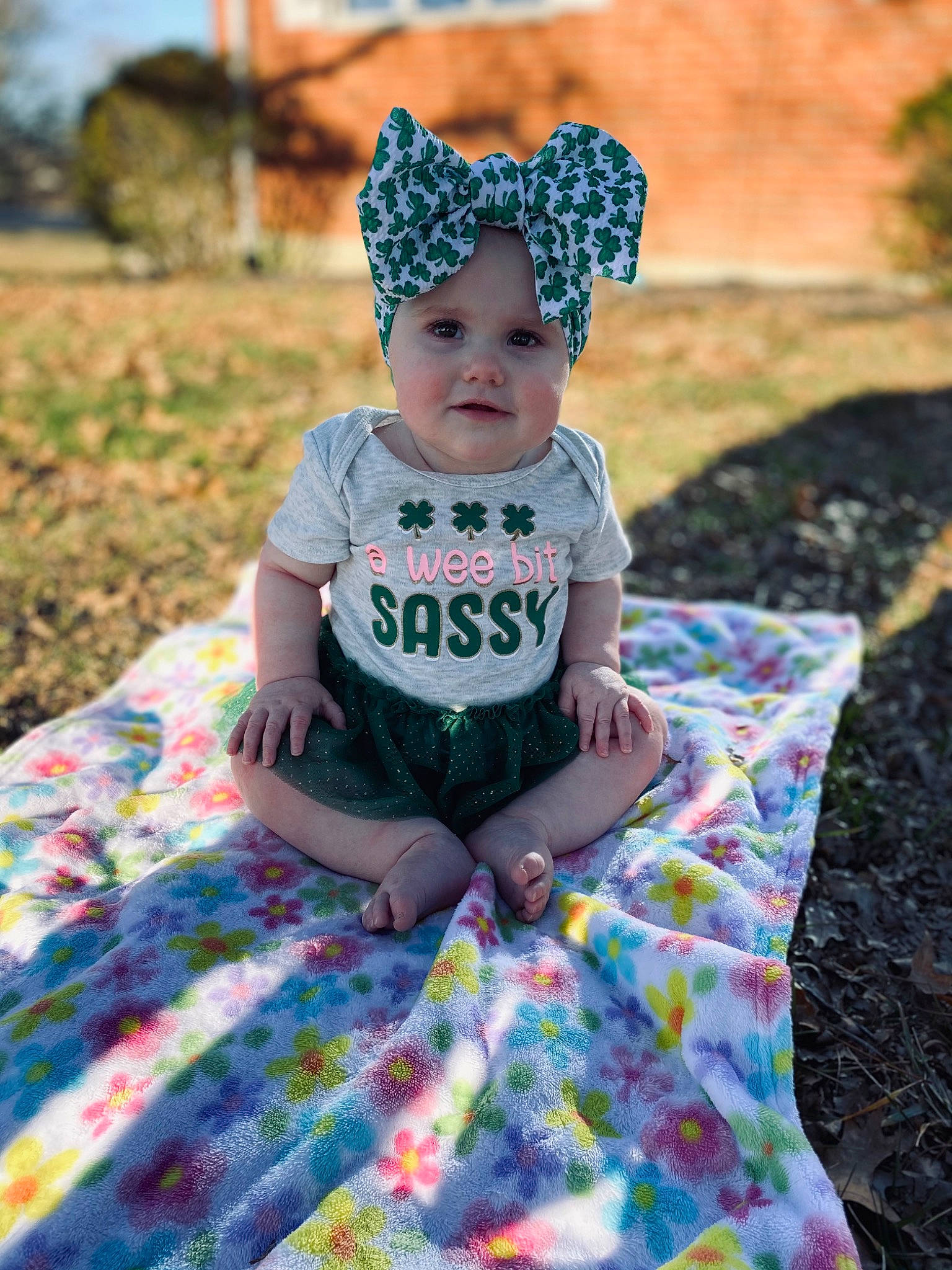 Mckenna is registered to the contest to win money with this photo: baby, baby_toddler_clothing, child, fun, grass, happy, headwear, leisure, light, magenta, pattern, person, photograph, plaid, plant, recreation, sitting, summer, t_shirt, tartan