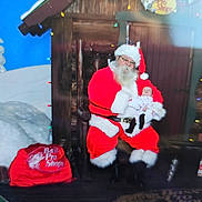 Freyja is registered to the contest to win money with this photo: baby, beard, celebration, chair, child, christmas, decorations, festive, glasses, holiday, indoor, pajamas, person, portrait, presents, red_suit, santa_claus, smile, snow, winter