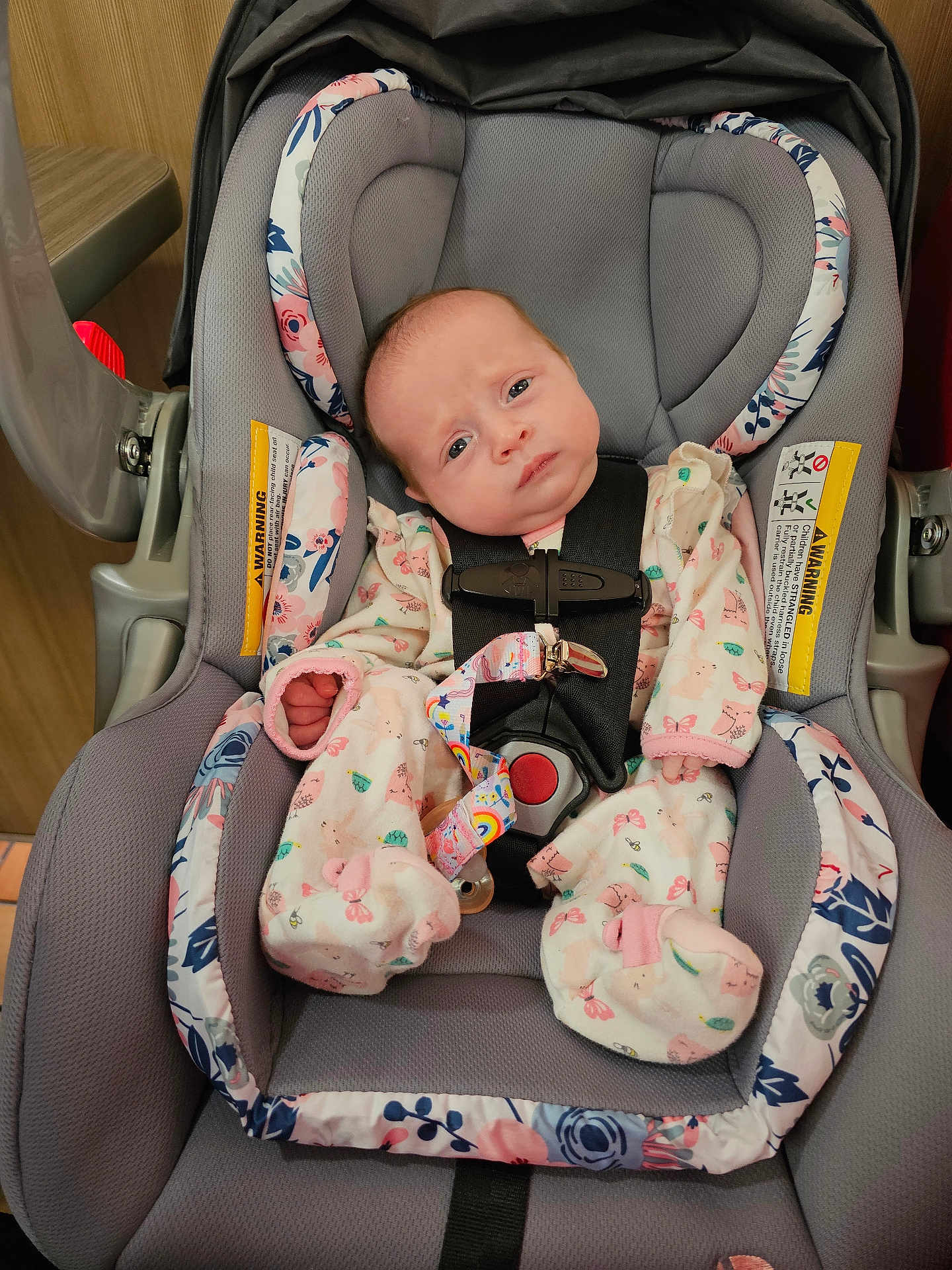 Freyja is registered to the contest to win money with this photo: baby, car_seat, infant, clothing, onesie, face, straps, safety, indoors, cute, child, person, expression, seat, fabric, pattern, pink, blue, newborn, head