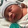 Xavier is registered to the contest to win money with this photo: newborn, baby, sleeping, hat, pacifier, blanket, towel, hospital, swaddled, infant, face, closeup, resting, cute, peaceful, child, soft, skin, indoors, portrait