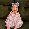 baby, bow, child, couch, dress, eyes, face, fashion, floral_dress, green, happy, headband, indoor, infant, legs, photography, pink, portrait, sitting, smiling