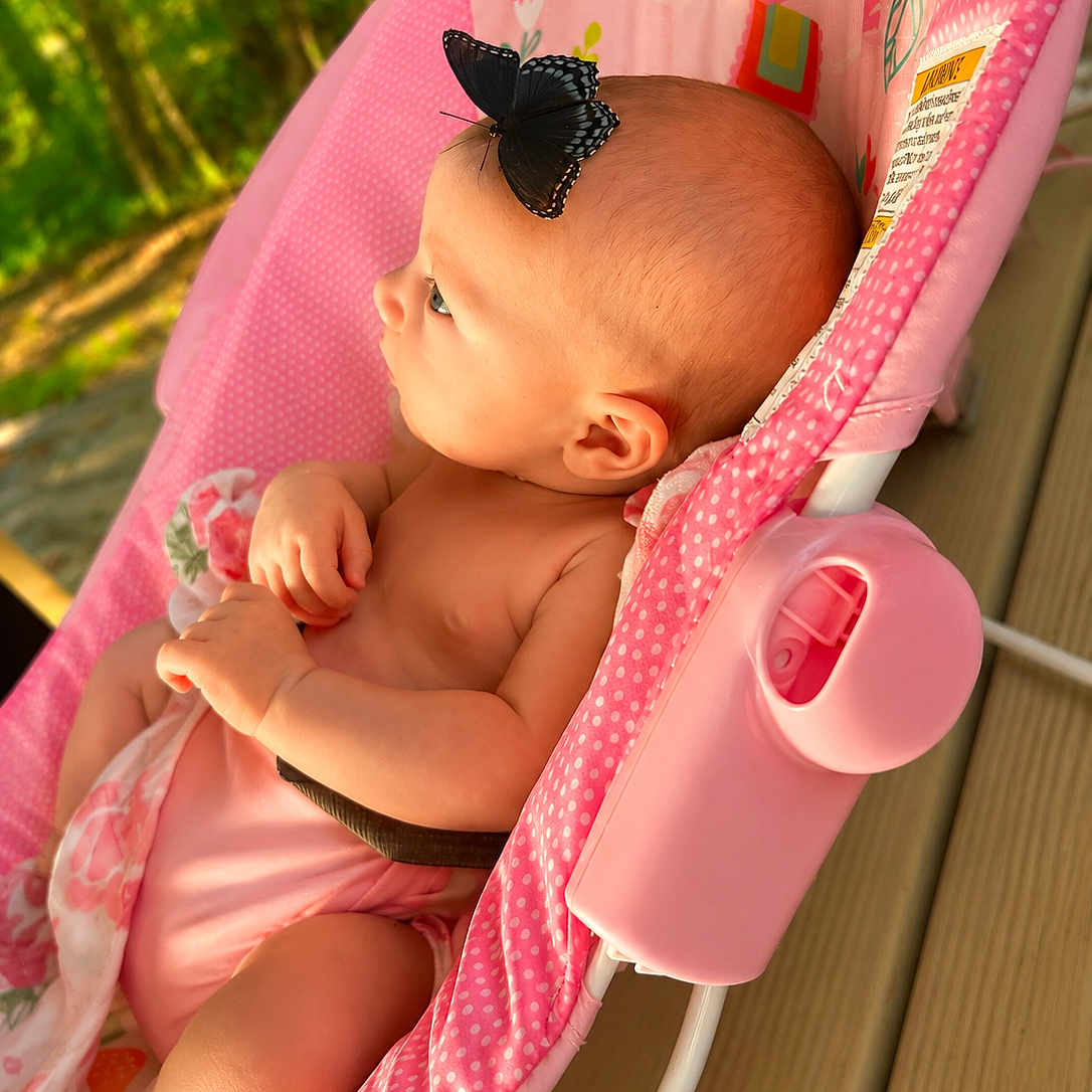 Elatia Jane is registered to the contest to win money with this photo: baby, blanket, bouncer, butterfly, child, clothing, face, floral, garden, infant, insect, nature, outdoor, photography, pink, portrait, profile, reclining, sitting, sunlight