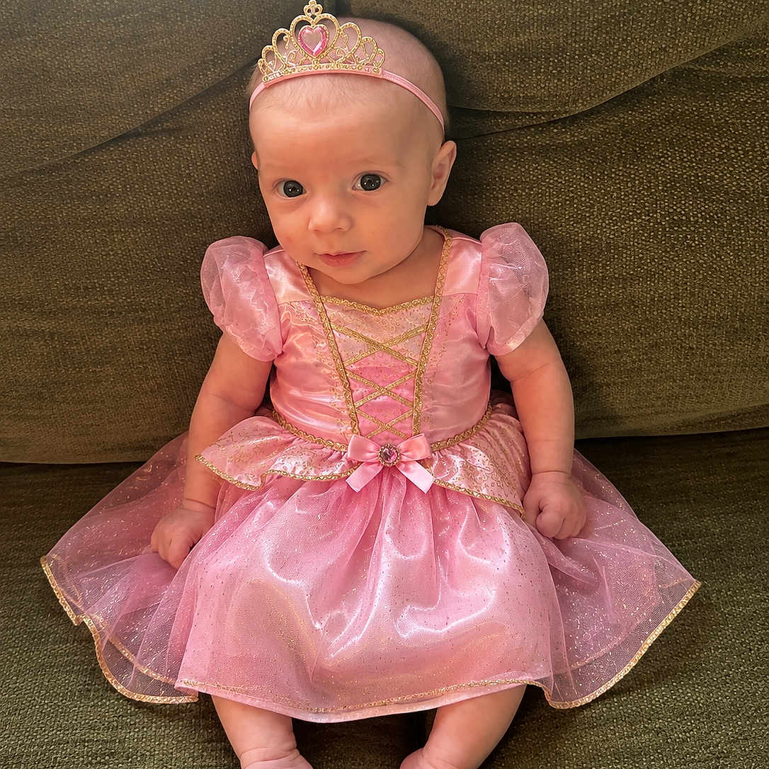 Elatia Jane joined the competition — help win amazing prizes! baby, infant, princess_costume, pink_dress, tiara, couch, green_couch, sitting, cute, child, portrait, indoor, adorable, young_child, headband, small_feet, puffy_sleeves, sparkly, fabric, person