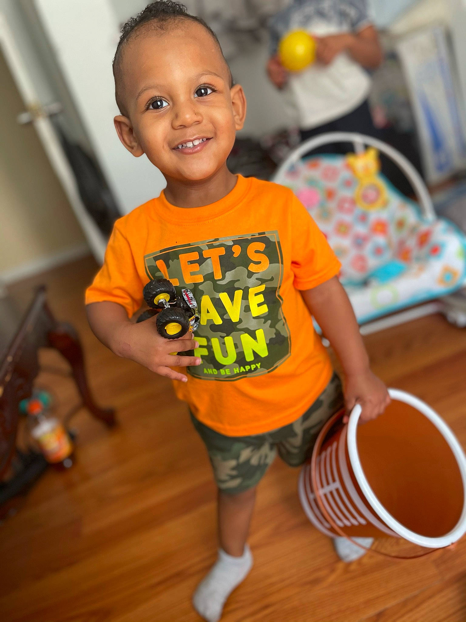 Kamari joined the competition — help win amazing prizes! baby, baby_toddler_clothing, cheek, child, floor, flooring, fun, happy, hardwood, joy, leisure, orange, person, play, shorts, sleeve, smile, standing, t_shirt, toddler