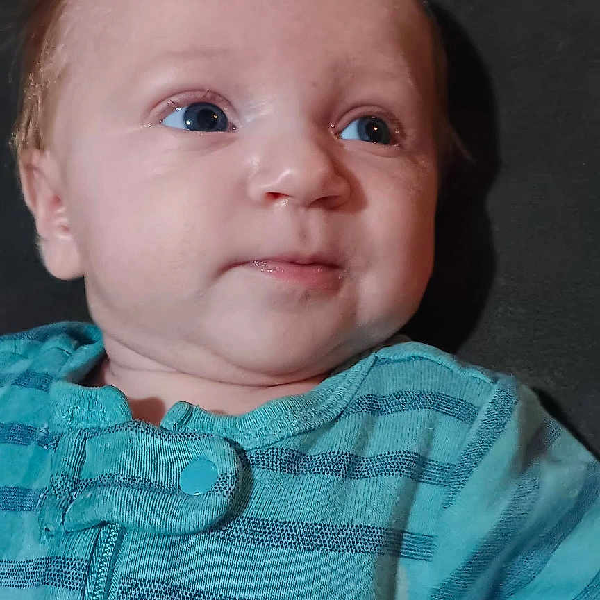 Bowen J. joined the competition — help win amazing prizes! baby, infant, child, blue_eyes, striped_clothing, onesie, face, portrait, cute, resting, cushion, indoor, young_child, person, looking_away, soft_lighting, head, skin, expression, teal