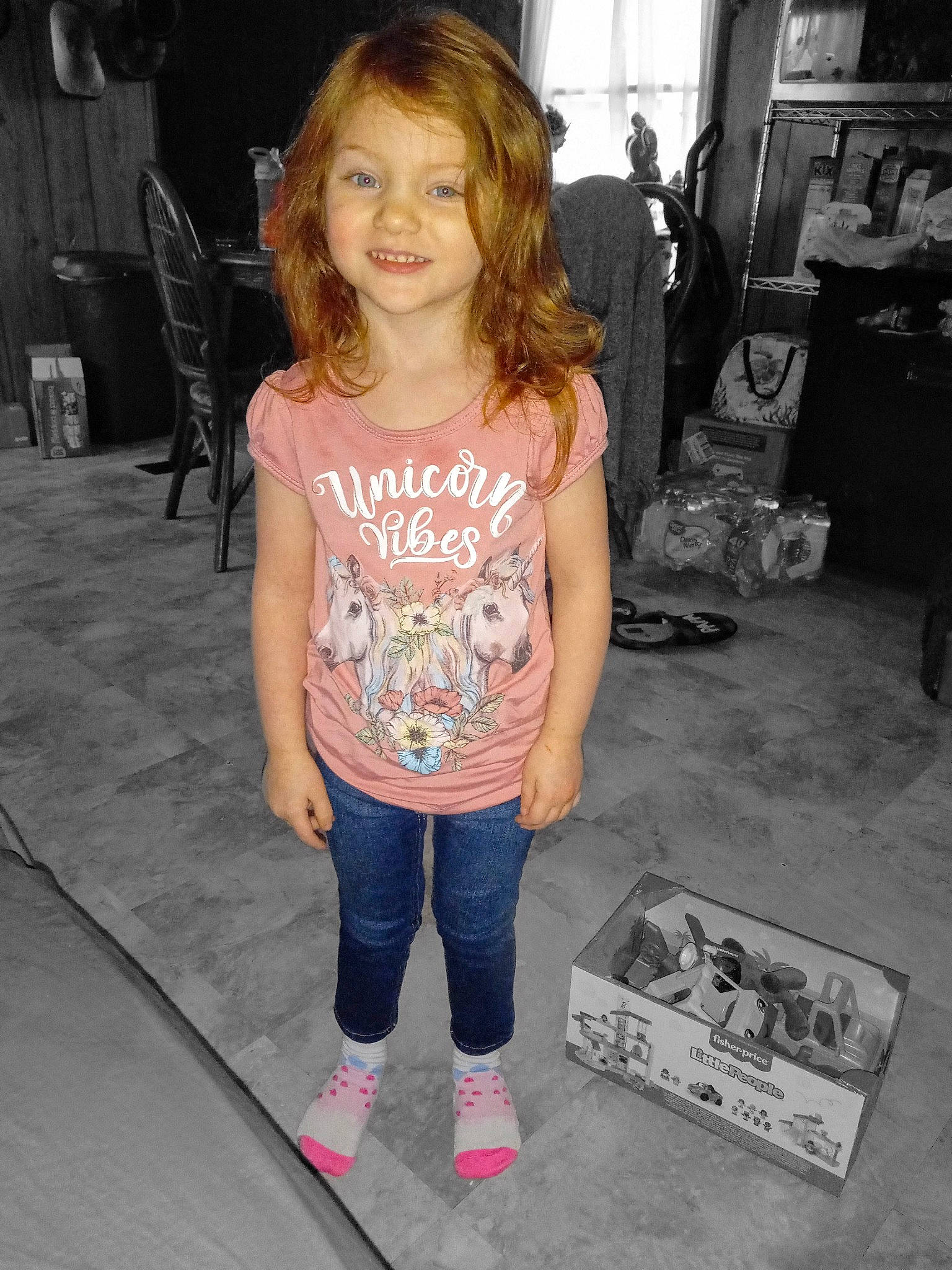 Julianna is registered to the contest to win money with this photo: blond, box, child, cool, denim, floor, flooring, fun, hairstyle, happy, human_leg, joy, leisure, person, sleeve, smile, sportswear, t_shirt, thigh, toddler