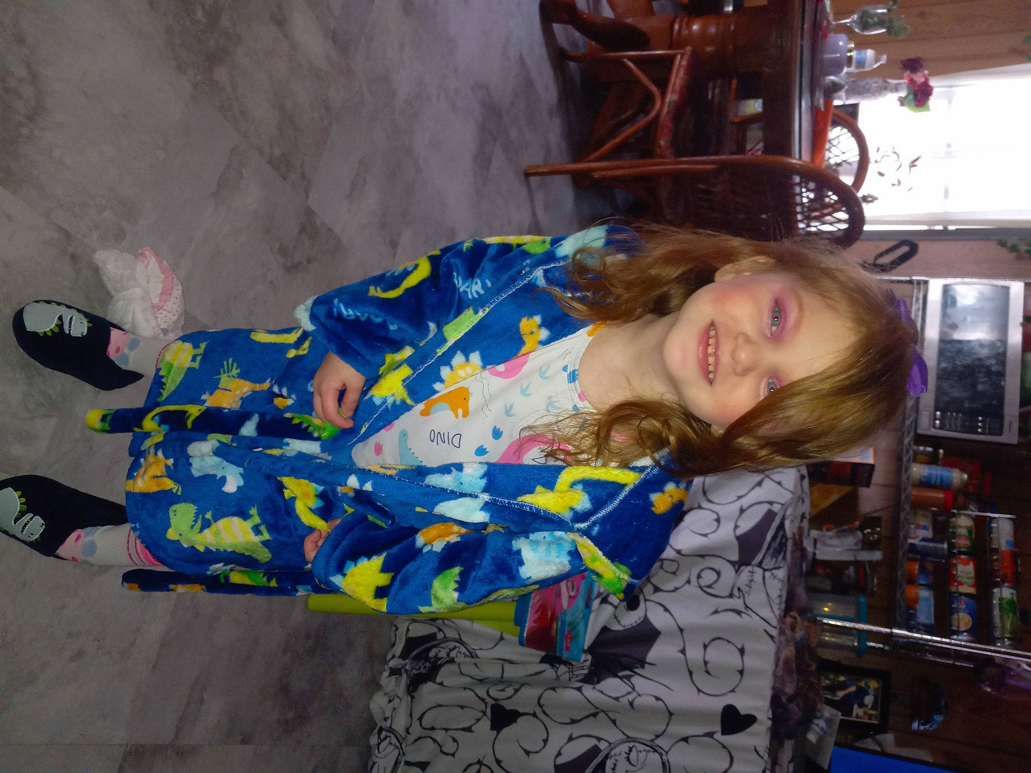 Julianna is registered to the contest to win money with this photo: child, comfort, electric_blue, flooring, fun, human_leg, joy, leisure, machine, pattern, person, sitting, thigh, travel, visual_arts