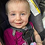 Nevaeh is registered to the contest to win money with this photo: baby, child, car_seat, straps, smile, blue_eyes, plush_toy, purple_shirt, infant, seatbelt, warning_label, safety, cute, closeup, indoors, person, young_child, happy, face, baby_toy